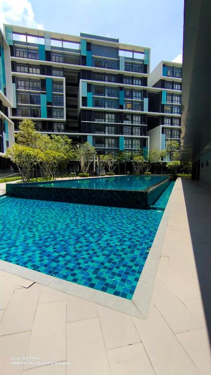 a swimming pool in front of a building at KLIA AIRPORT HOMESTAY 3 in Sepang