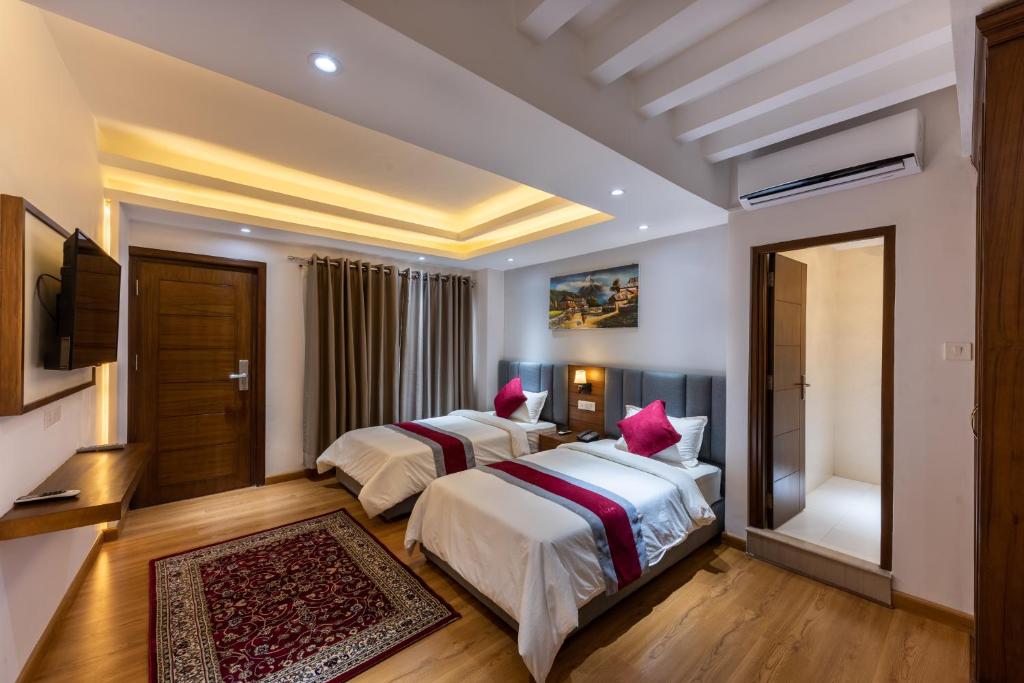 Postel nebo postele na pokoji v ubytování Hotel Ama-La, Thamel, Kathmandu