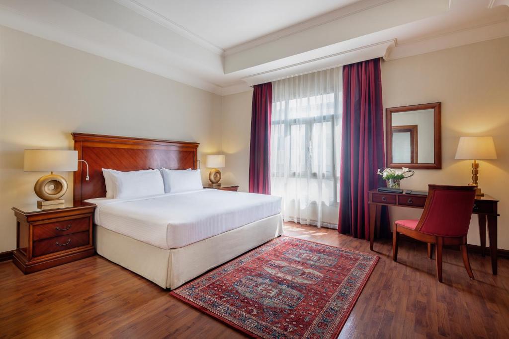 Postel nebo postele na pokoji v ubytování Concorde Hotel Doha