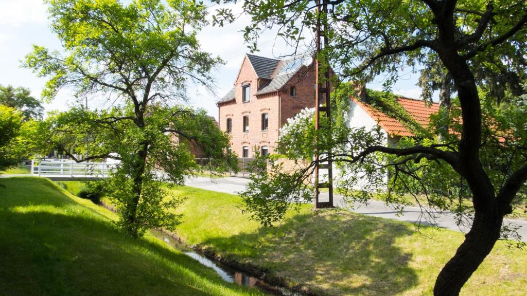 a large brick building in the middle of a yard at Historische Ferienwohnung für bis 5 Personen in Spremberg