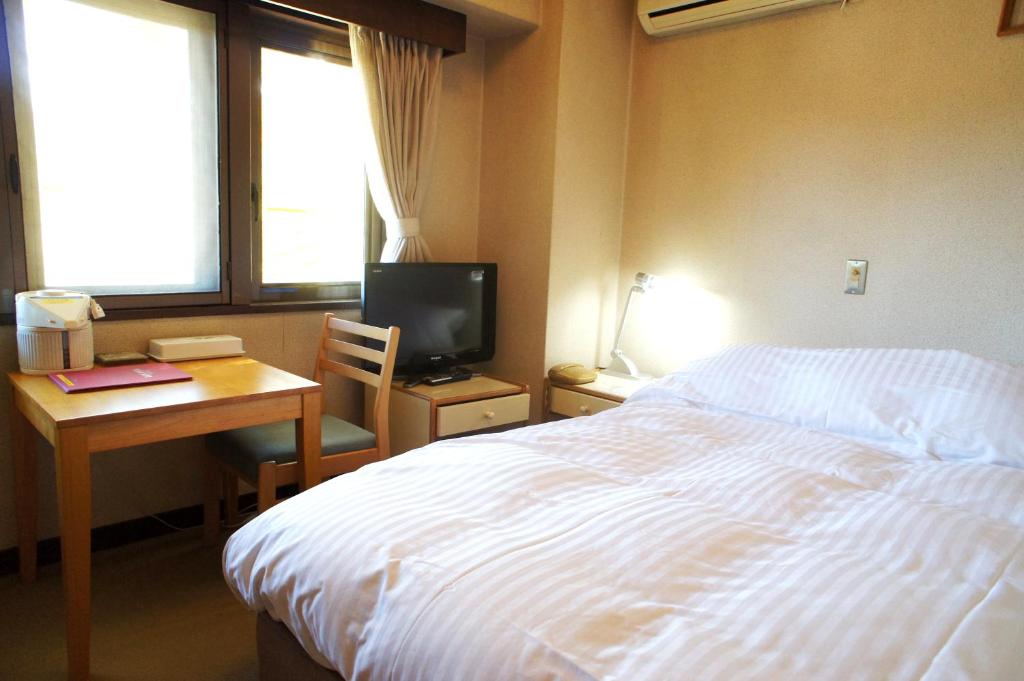 Postel nebo postele na pokoji v ubytování Petit Hotel Shitaka