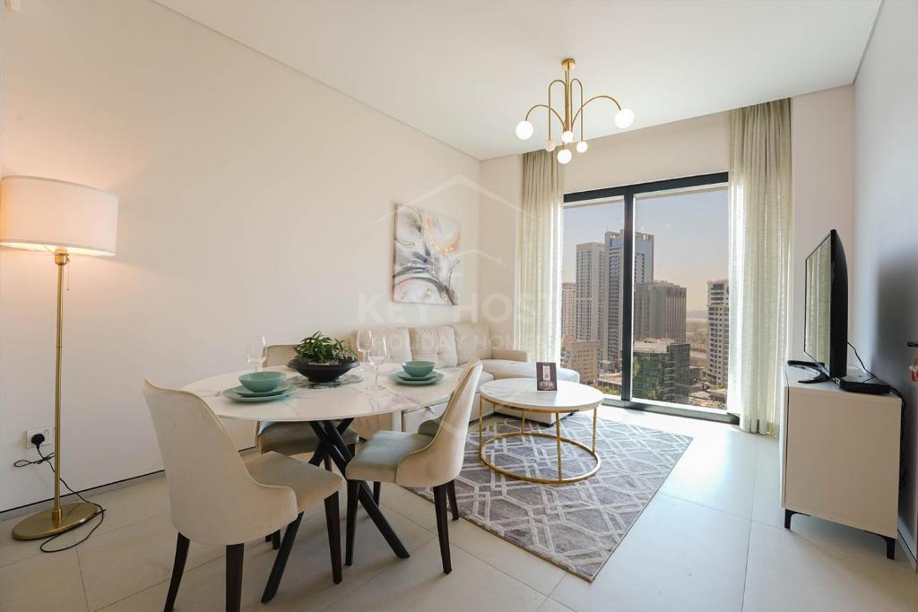 a dining room with a table and chairs and a window at KeyHost - Stunning 1BR - The Address Beach Residences JBR -Dubai Marina View - K1470 in Dubai