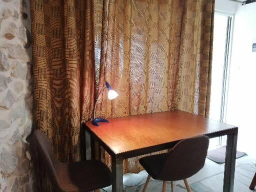 a table with two chairs and a lamp on it at Lonos Circle Terrace view in Romblon