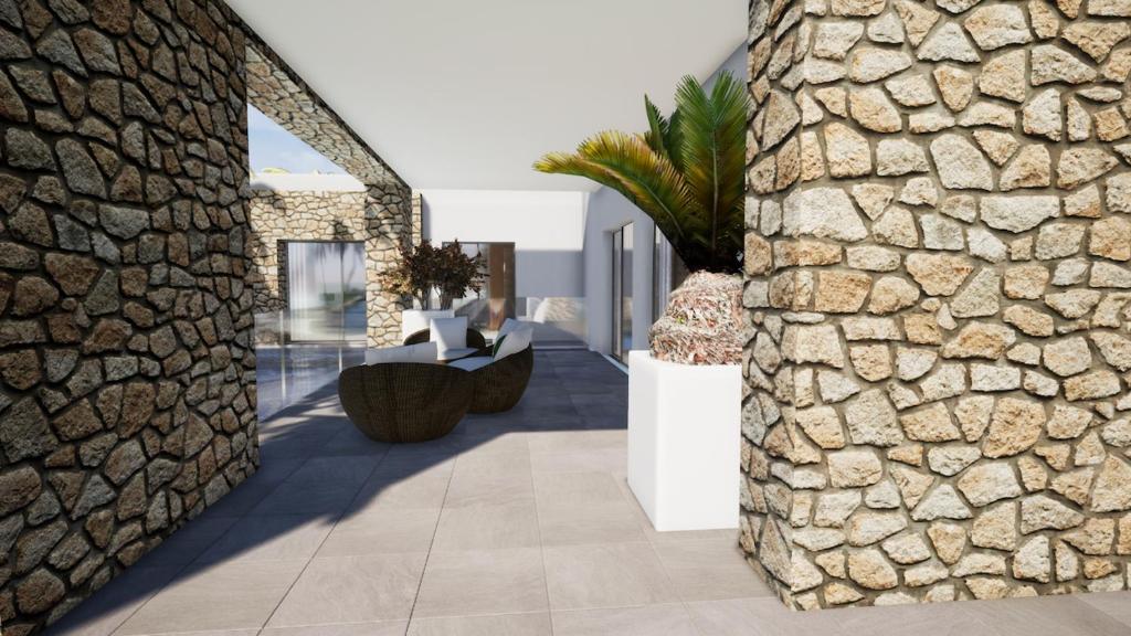 una pared de piedra en una sala de estar con una pared de piedra. en CDM Villas Kiwengwa en Kiwengwa