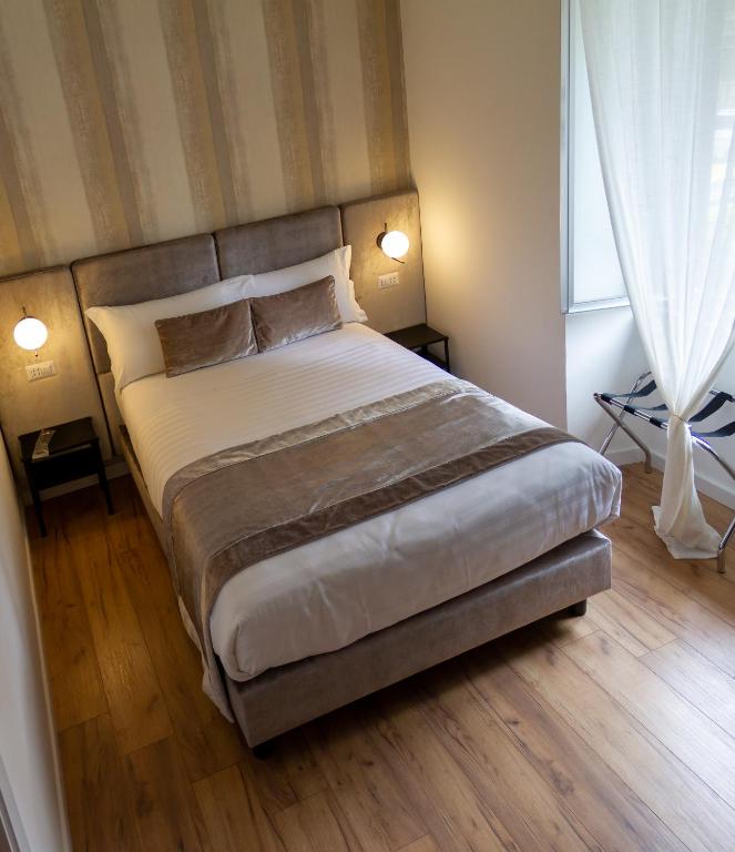 A bed or beds in a room at Home at Rome St. Peter Guest House