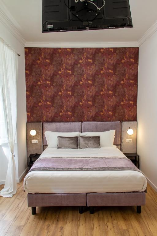A bed or beds in a room at Home at Rome St. Peter Guest House