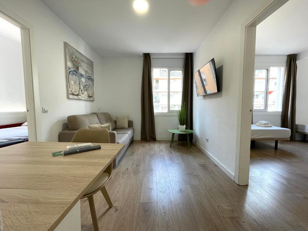 a living room with a couch and a table at Apartamentos Venecia in Lloret de Mar