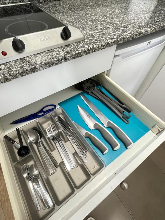 a drawer in a kitchen with utensils at Apartamentos Venecia in Lloret de Mar