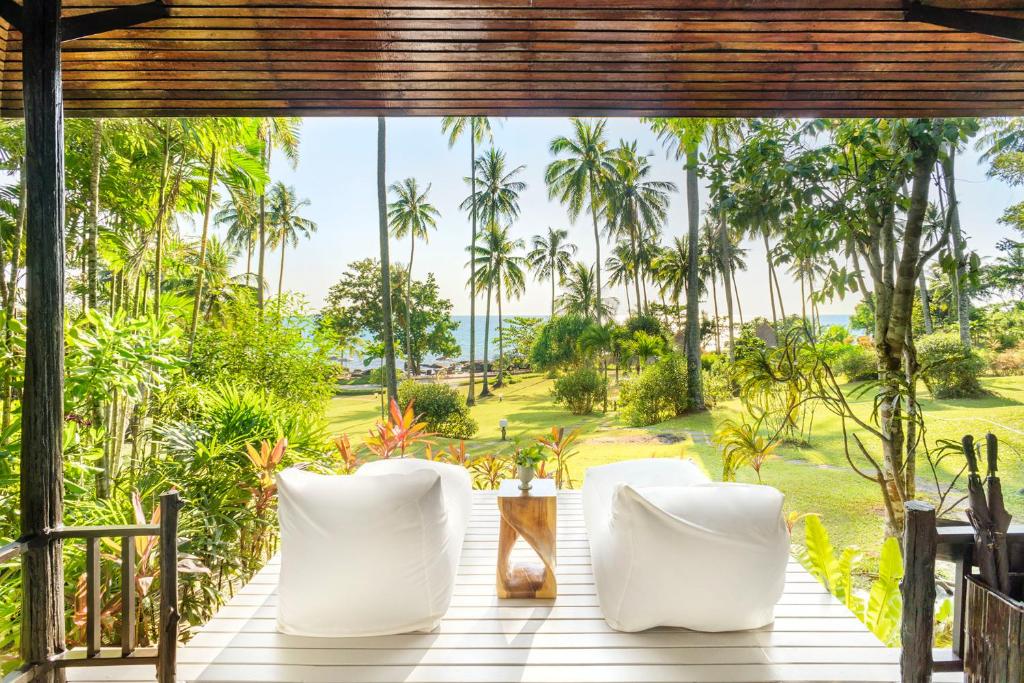 - une vue depuis la terrasse couverte d'un complexe avec des palmiers dans l'établissement Shantaa Resort, Kohkood, à Ko Kood