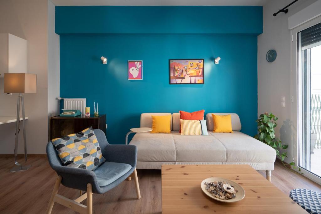 a bedroom with a bed and a blue wall at Exclusive apartment in the heart of Athens in Athens