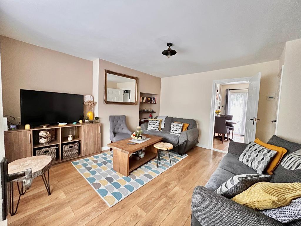 a living room with a couch and a table at Guest House Rooms Birmingham in Birmingham