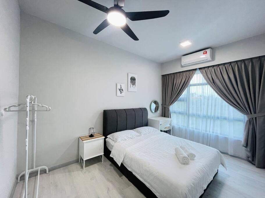 a bedroom with a bed and a ceiling fan at Jesselton Quay,2BR,4-5pax,Mountain view in Kota Kinabalu
