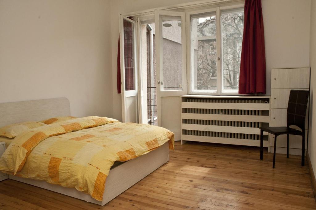 
a bed sitting in a room next to a window at Hostel Mostel Sofia in Sofia
