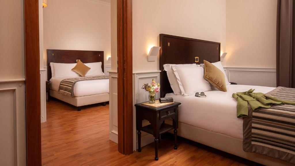 Postel nebo postele na pokoji v ubytování Hotel Del Corso