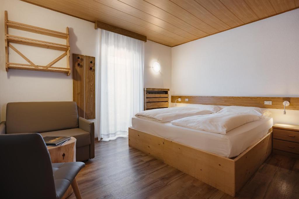 Postel nebo postele na pokoji v ubytování Hotel La Montanara Predazzo