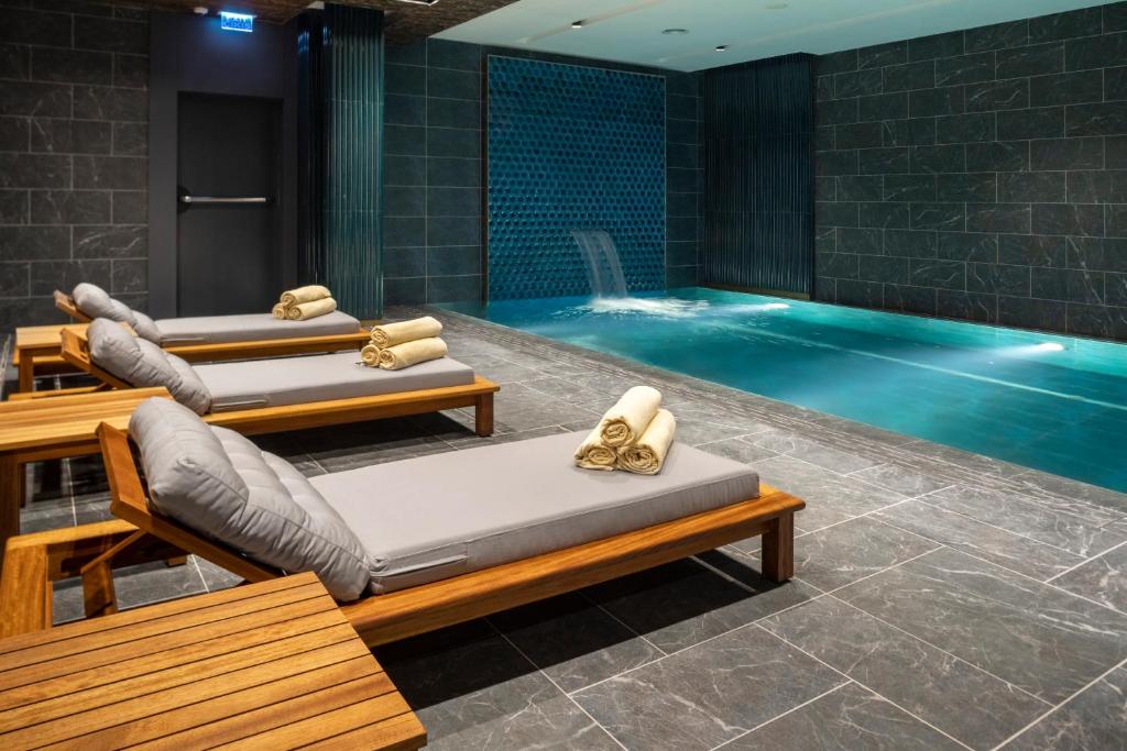 a swimming pool with two beds in a room at Wish More Hotel Şişli in Istanbul