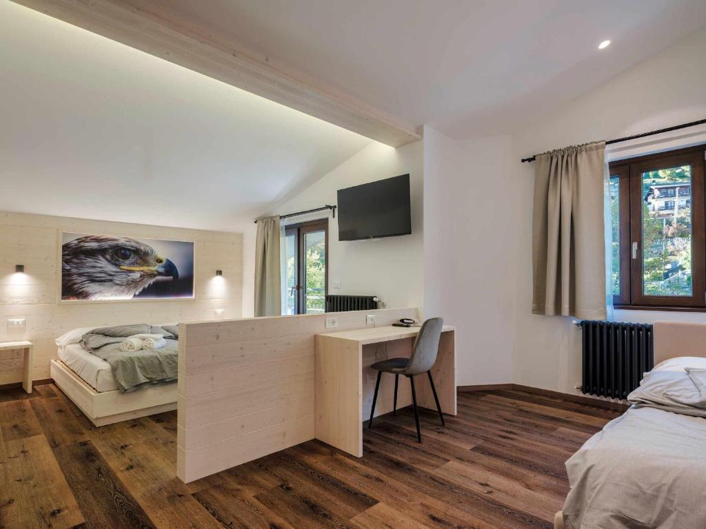 Postel nebo postele na pokoji v ubytování Hotel Garnì Alta Valle