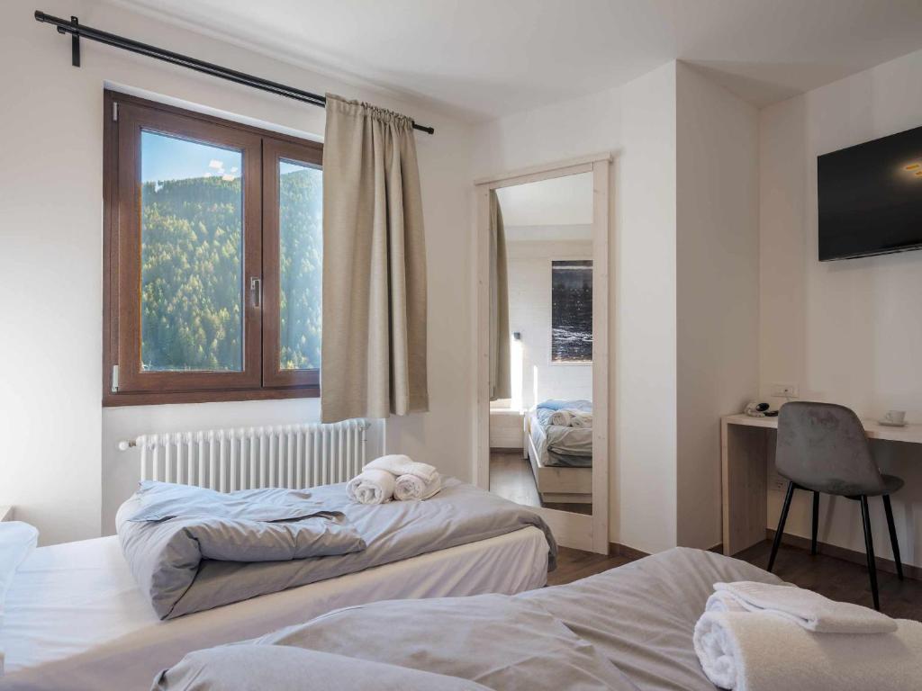 Postel nebo postele na pokoji v ubytování Hotel Garnì Alta Valle