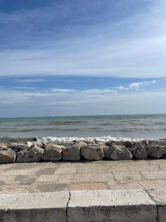 a row of rocks next to the ocean at Villa AMARE in Caorle