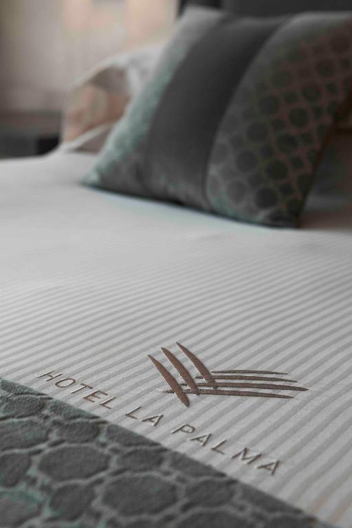 Postel nebo postele na pokoji v ubytování Hotel La Palma