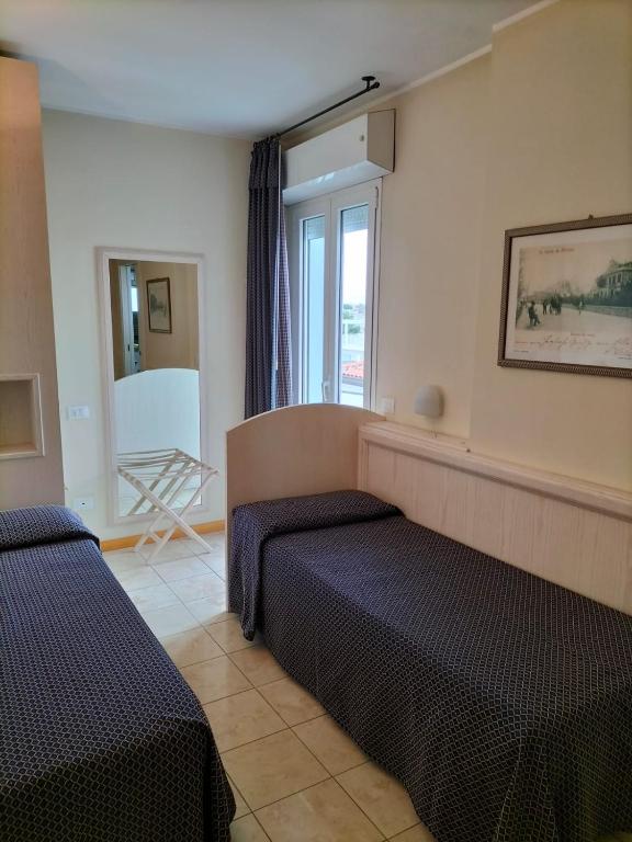 Postel nebo postele na pokoji v ubytování Hotel Villa Mare
