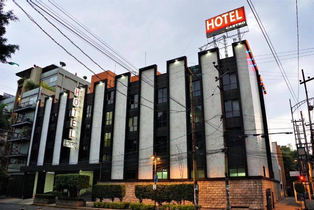a hotel with a sign on the side of it at Hotel Castro in Mexico City
