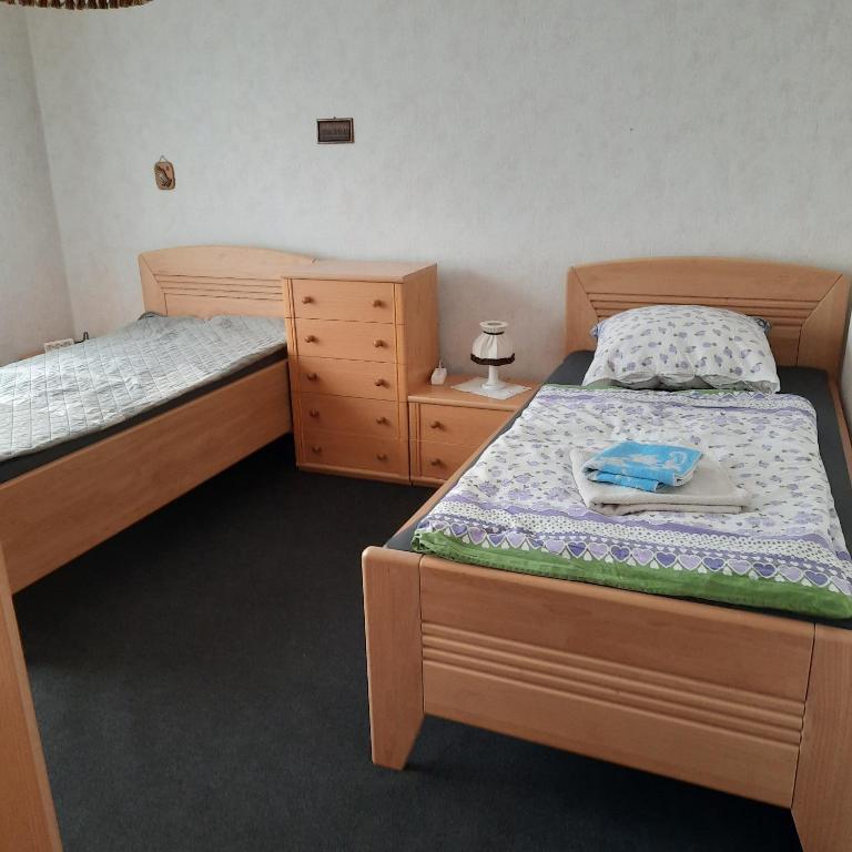 a bedroom with two twin beds and a dresser at Lütke-Dörhoff in Ennigerloh