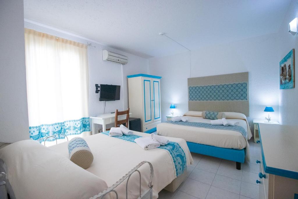 Postel nebo postele na pokoji v ubytování Hotel Canne al Vento