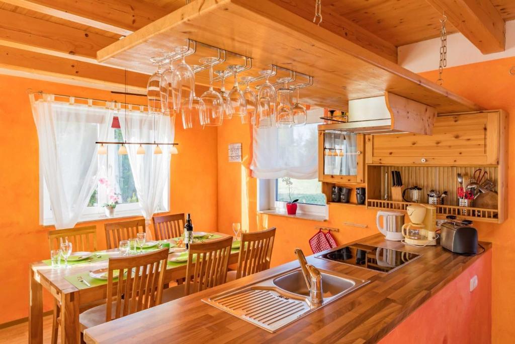 a kitchen with a sink and a table with chairs at Ferienhaus Wiesenblick 16 in Bannemin