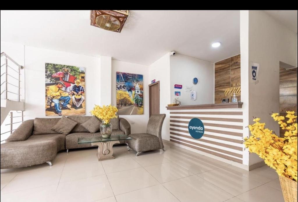 a living room with a couch and a table at Hotel Millrose in Valledupar