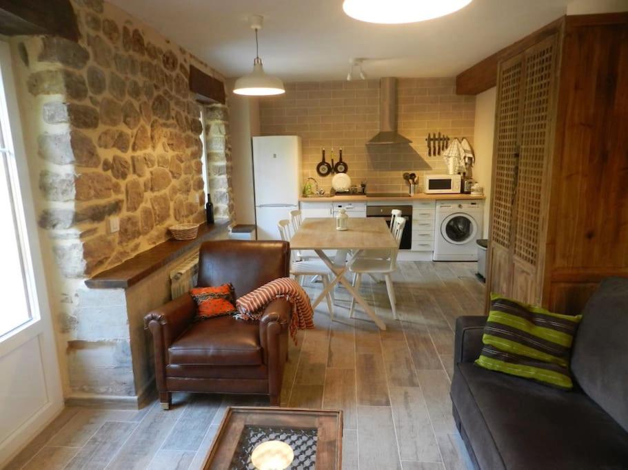 a living room with a couch and a table in a kitchen at Apartamento en Cantabria, Treceño in Treceño