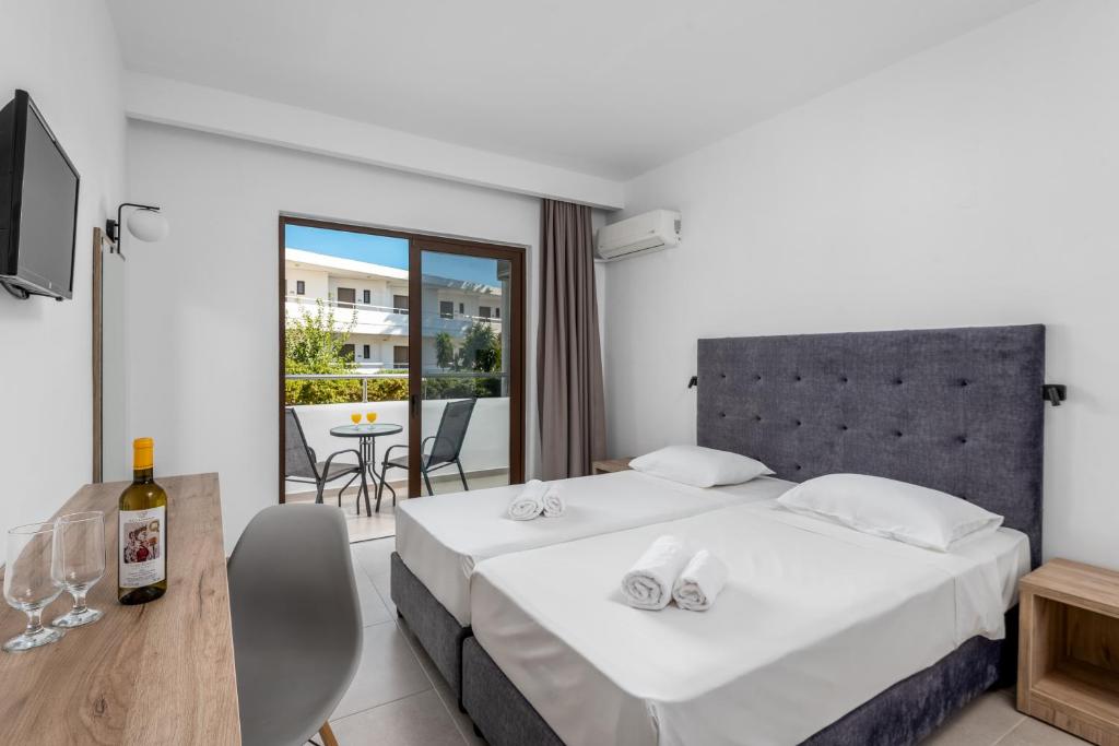 A bed or beds in a room at Afandou Blu
