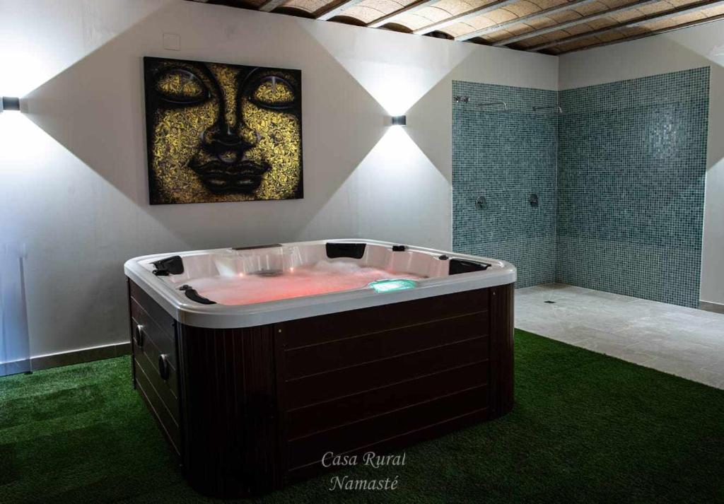 a jacuzzi tub with a face on the wall at Casa Rural Namasté con SPA in Lleida