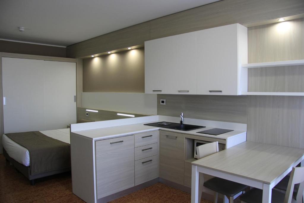 a kitchen with a white counter top and white cabinets at Residence all'Adige in Verona