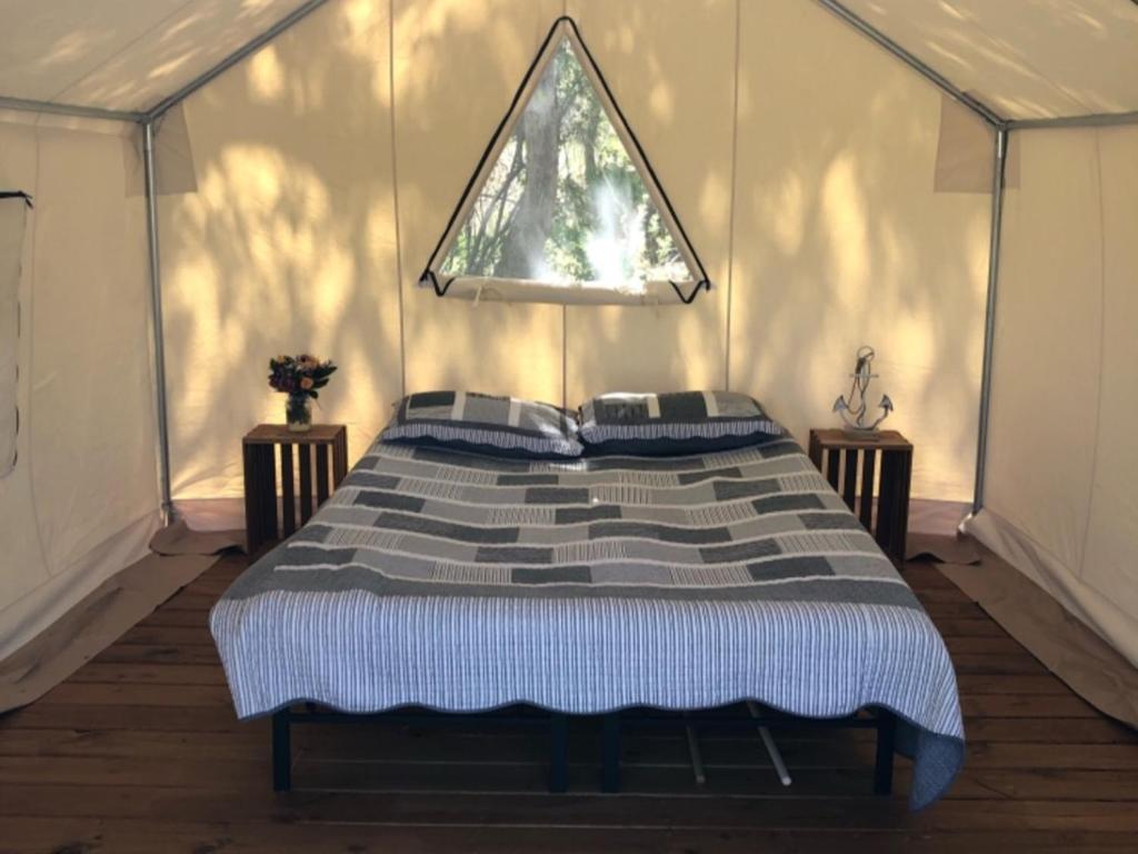 a bedroom with a large bed in a tent at Tentrr Signature Site - Los Pinos River Camp in Bayfield