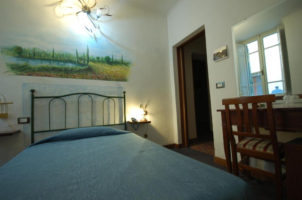 Postel nebo postele na pokoji v ubytování Hotel Leonardo