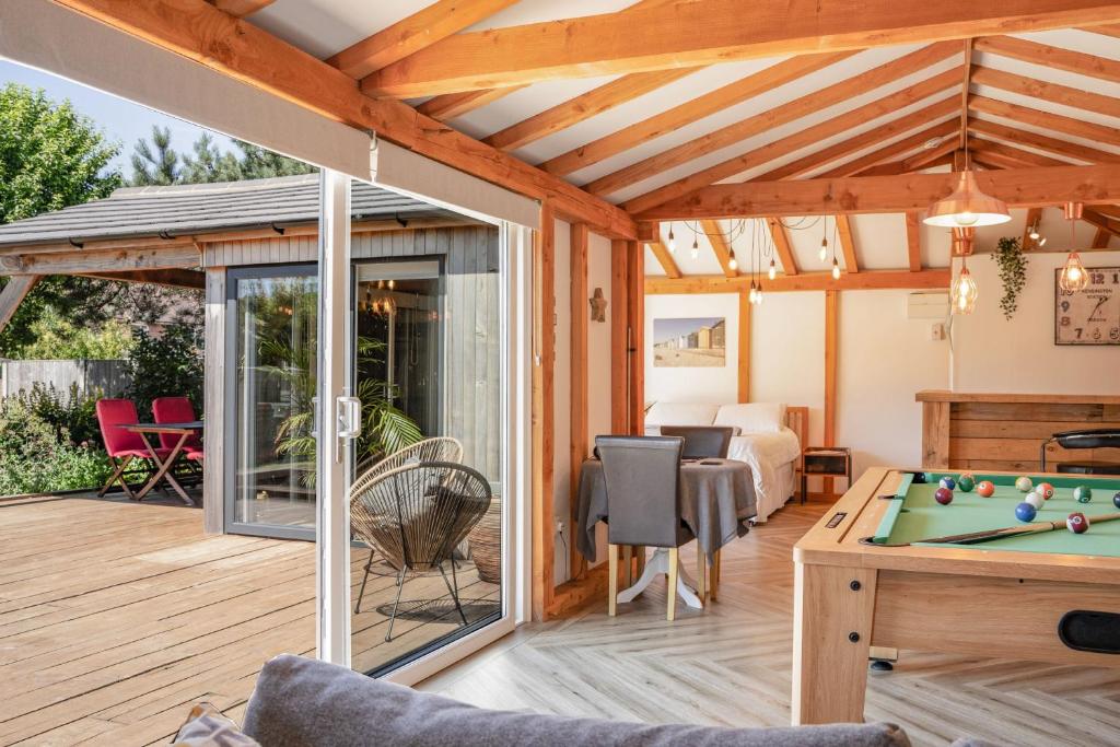 a screened in porch with a pool table at The Cabin in Fareham