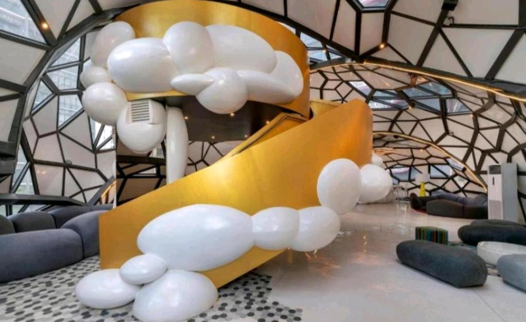 a room with a bunch of white spheres around a chair at Arte Plus AMPANG by Zzzayn in Batu Empat