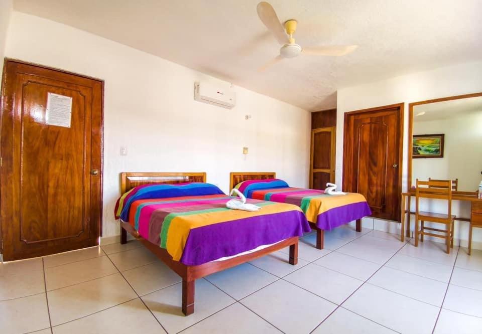 Ένα ή περισσότερα κρεβάτια σε δωμάτιο στο Hotel Martina’s