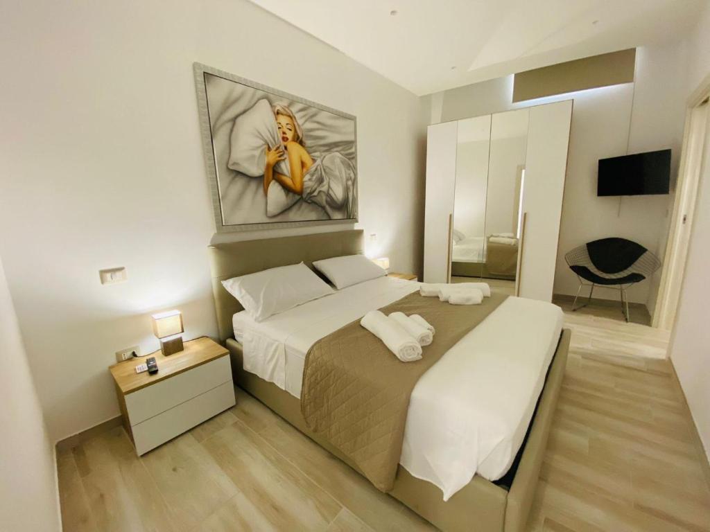 a bedroom with a large bed and a mirror at Nico's House in Brindisi