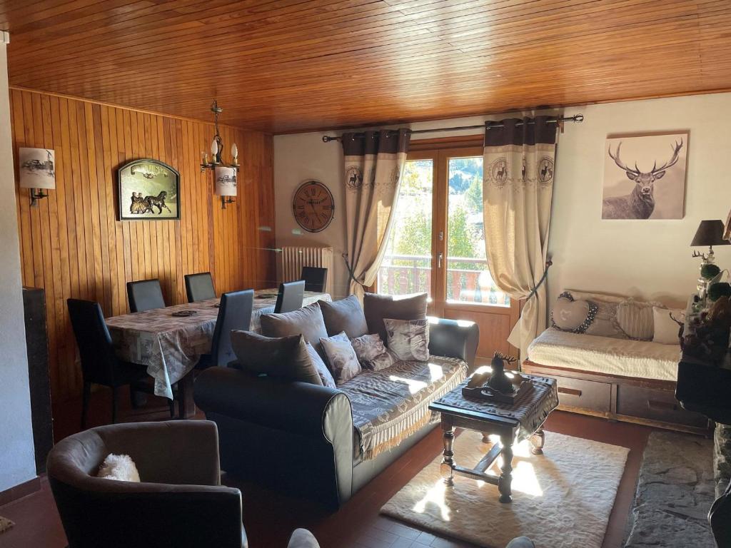 a living room with a couch and a table at Appartement La Clusaz, 3 pièces, 6 personnes - FR-1-459-43 in La Clusaz