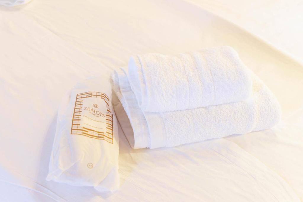 a white towel and a roll of toilet paper on a bed at Castello di Haria in Kaloú