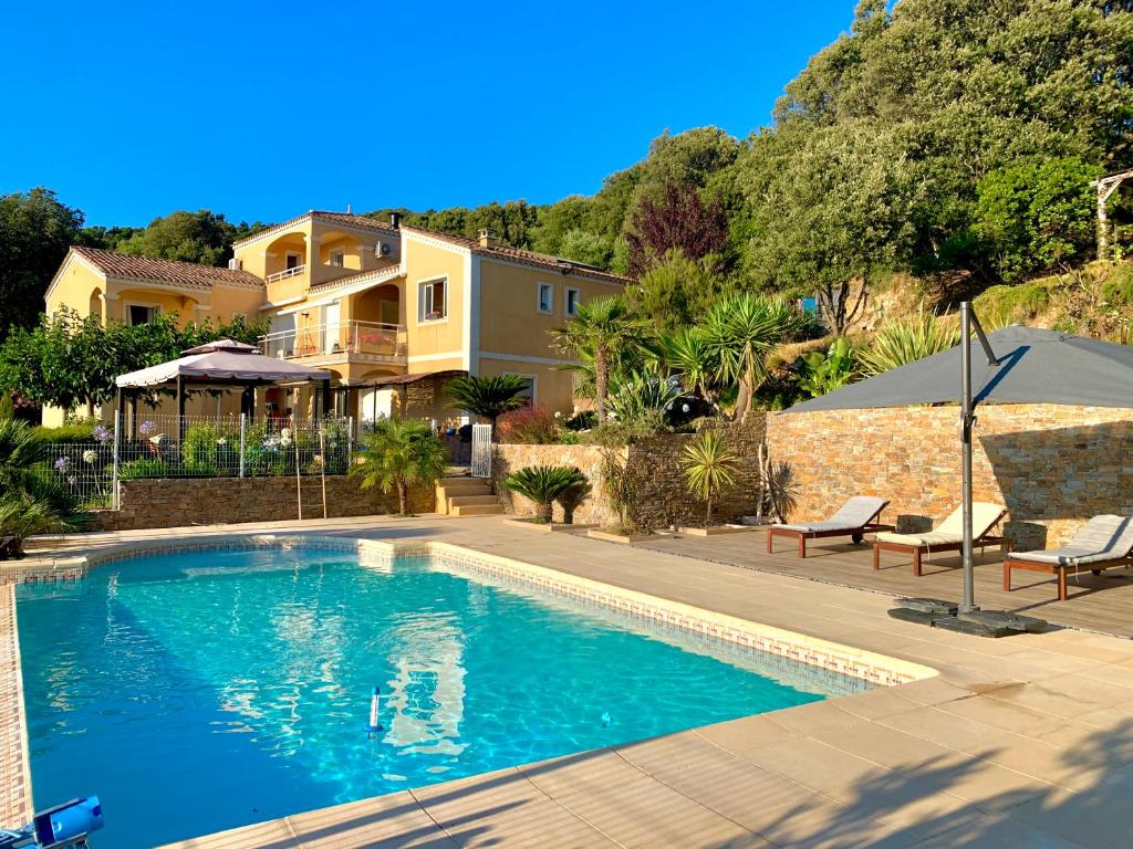 a swimming pool in front of a house at Villa U Tramontu in Granace