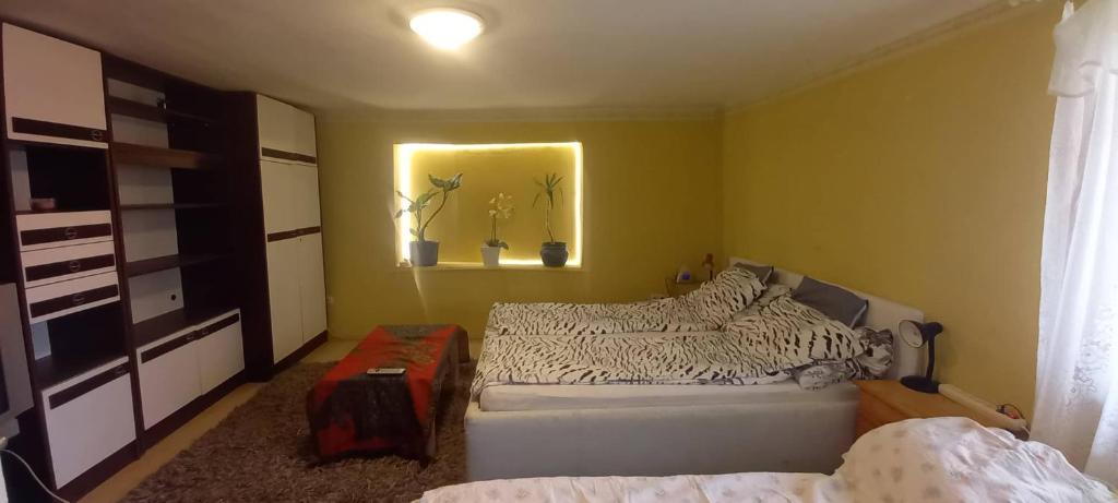 a bedroom with a white bed and a window at Gyöngyösi Kertes Ház in Gyöngyös