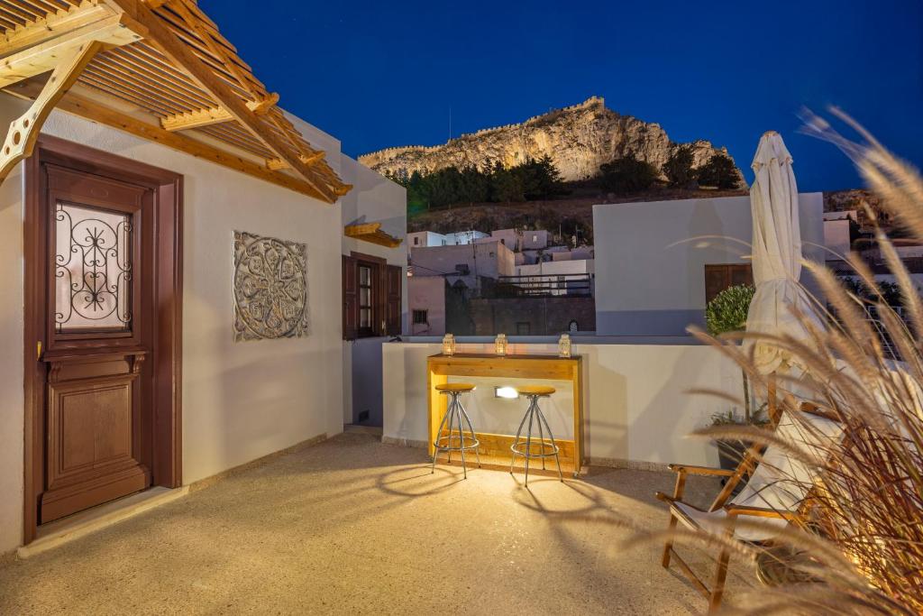 a balcony with a bar on the side of a house at Filigrana Villa Lindos in Lindos