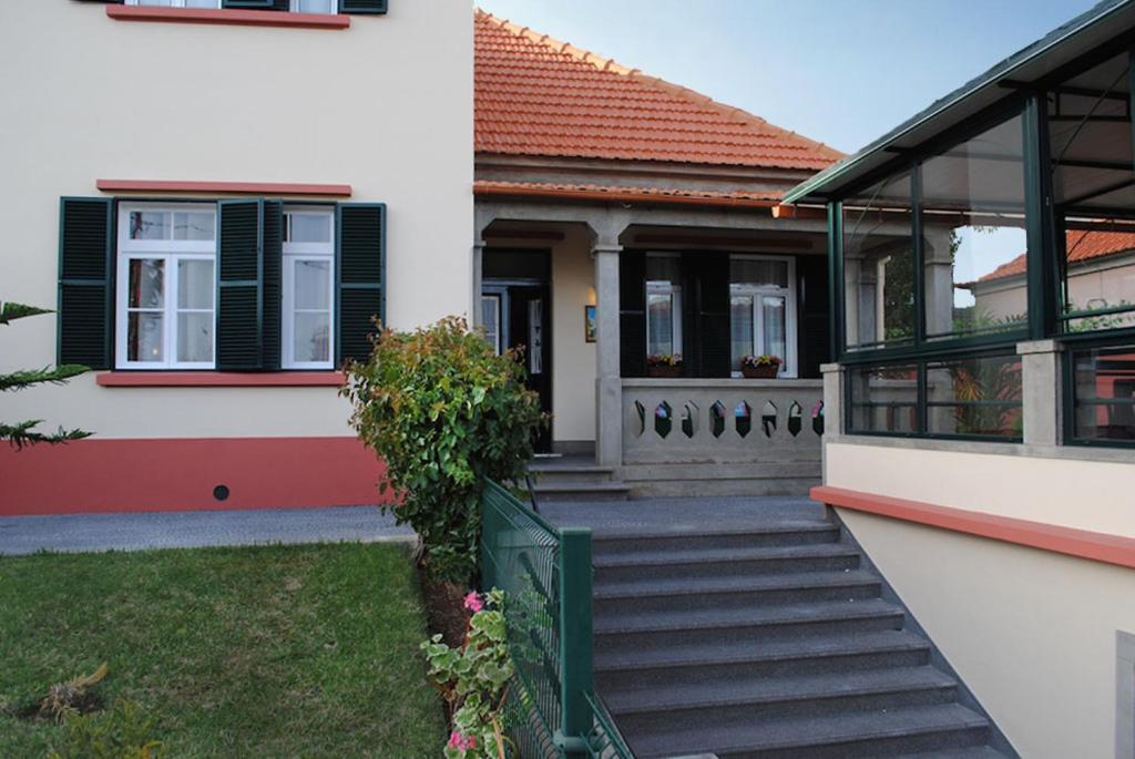 a house with a staircase leading to the front door at Quinta Mar & Sol in Funchal