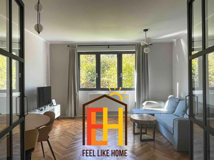 a living room with a blue couch and a table at FLH - Nana's apartment in Sibiu