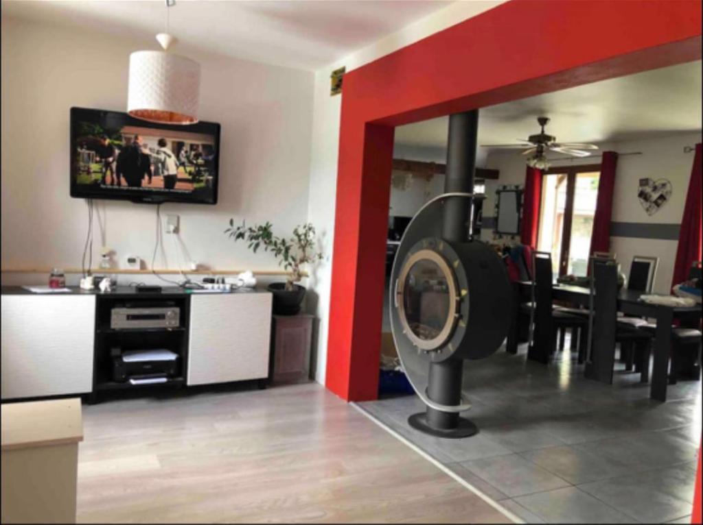 a living room with a treadmill and a dining room at Maison au cœur de luz sauveur in Luz-Saint-Sauveur