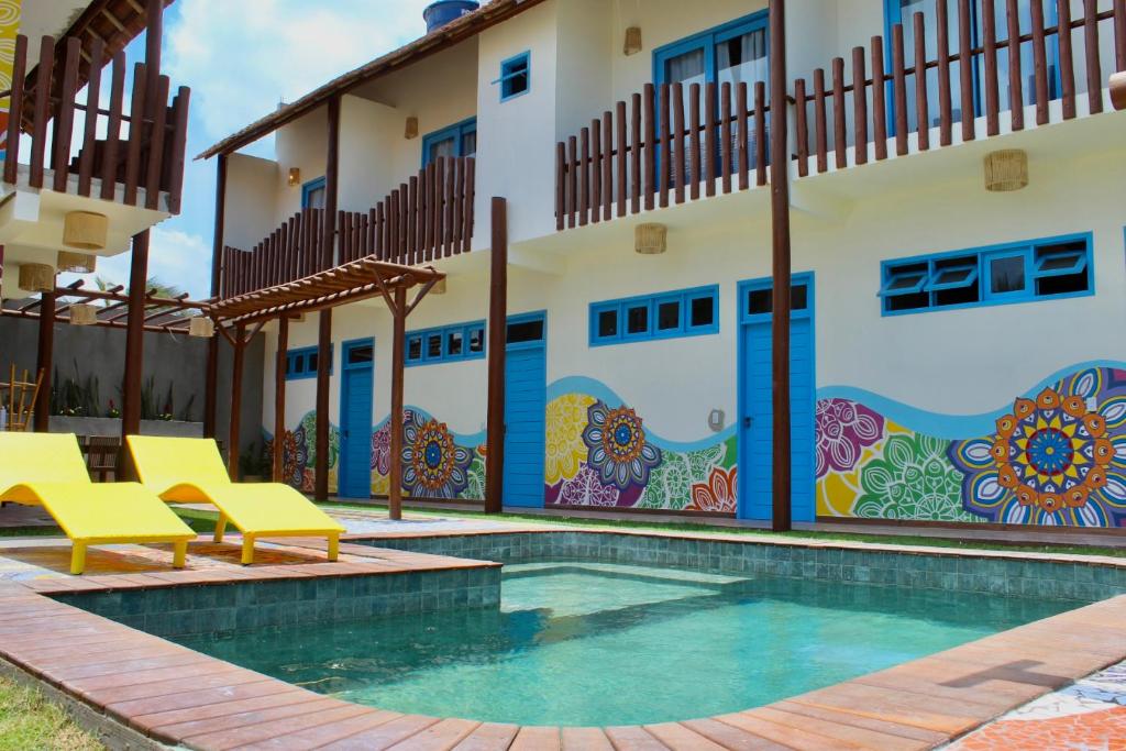 a villa with a swimming pool in front of a building at MAKTUB PREA HOSTEL in Prea