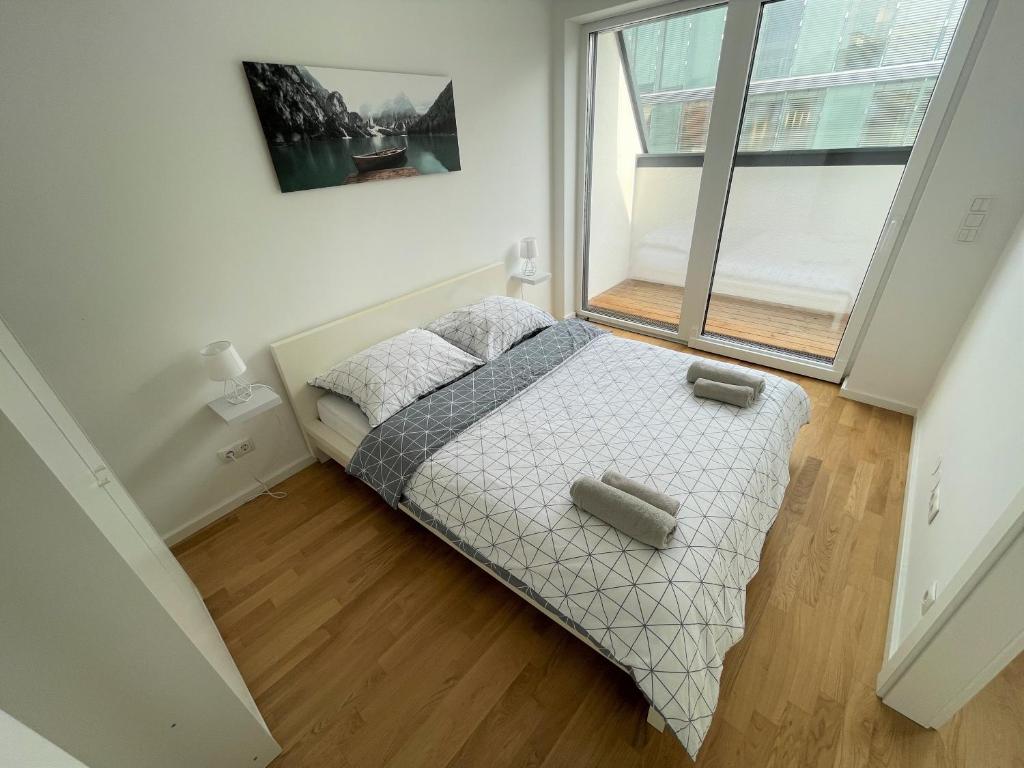 1 dormitorio con cama y ventana grande en Oidahome - Penthouse Apartment - contactless Self-Check-IN, en Viena